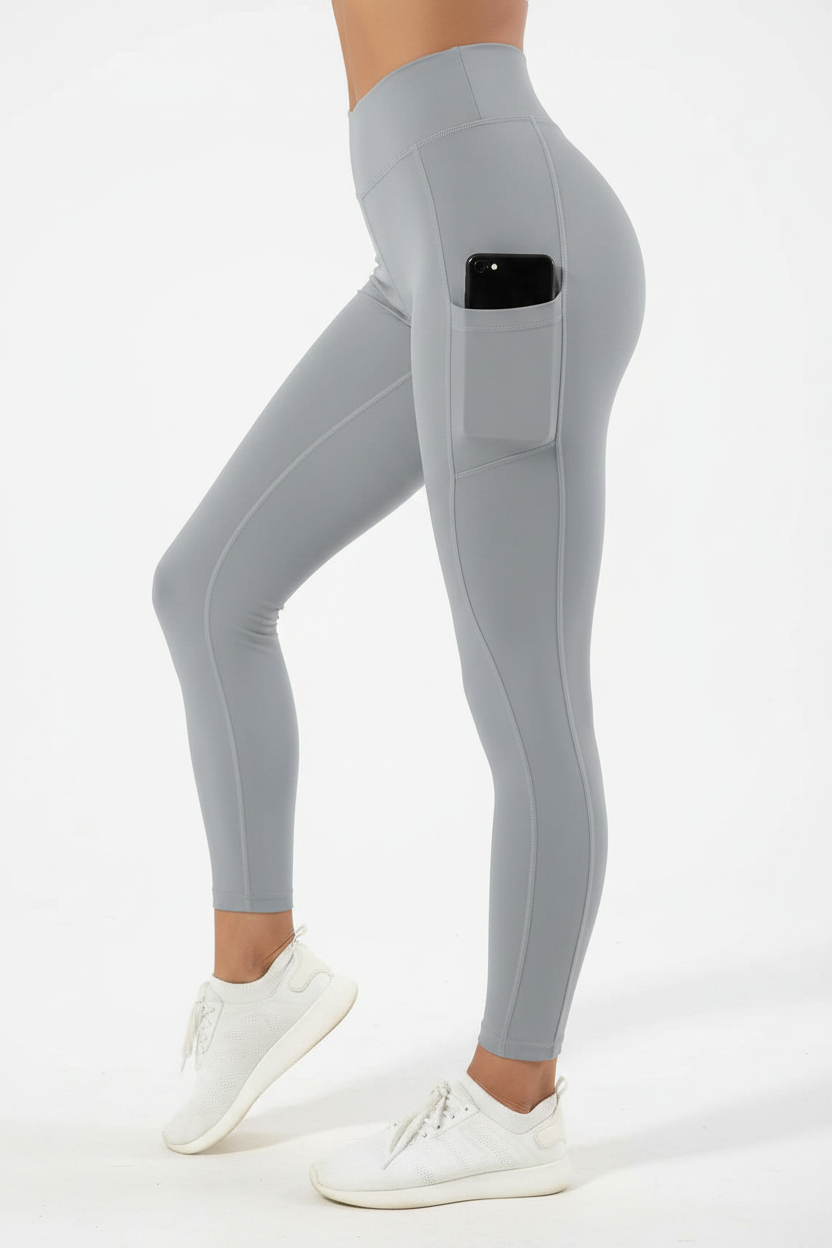Model wearing gray leggings with phone in side pocket